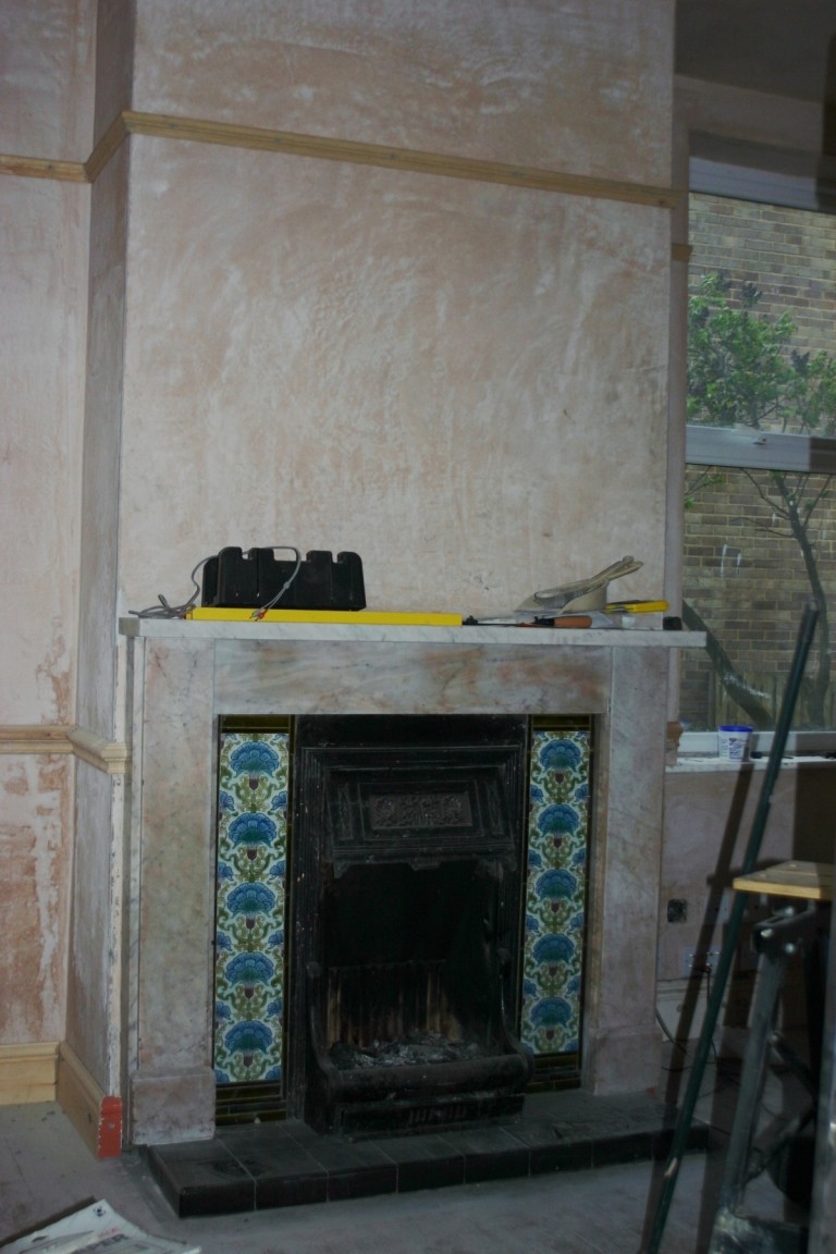 Living Room With Plaster And Fireplace